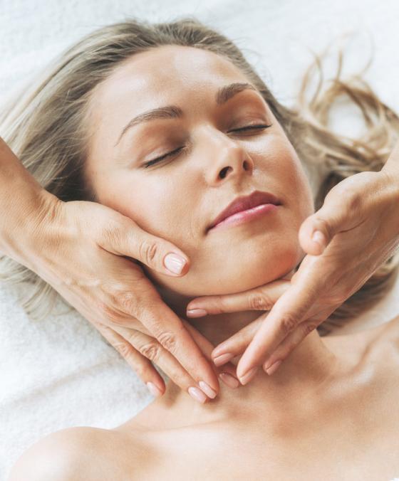 Facial massage at dermatology clinic to improve circulation, relax muscles, and enhance skin rejuvenation.
