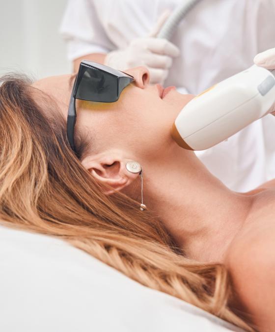 Laser hair removal on woman's face at dermatology clinic for smooth, hair-free skin.