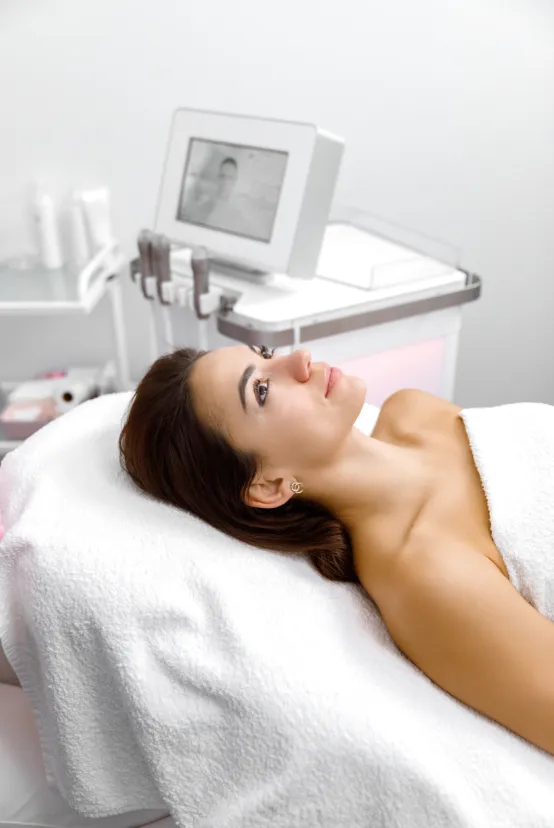 Patient relaxing before a dermatology treatment in a modern clinic for skin rejuvenation and care.