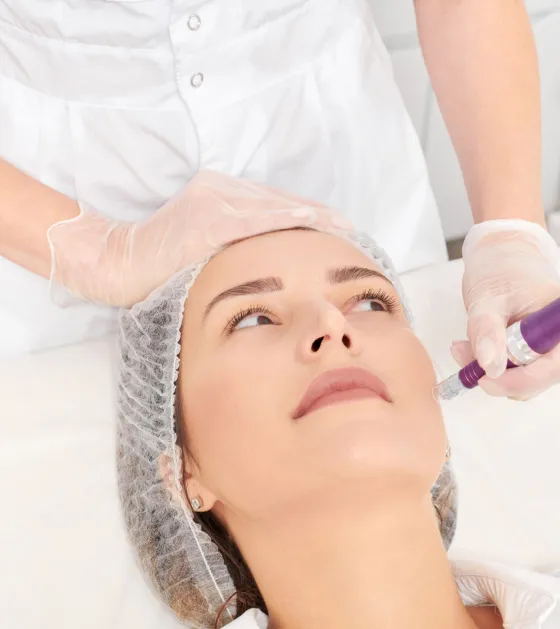 Microneedling treatment at dermatology clinic to stimulate collagen, reduce fine lines, and improve skin texture.