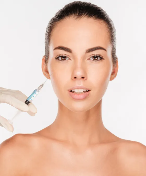 Dermal filler injection at dermatology clinic to restore volume, smooth wrinkles, and enhance facial contours.