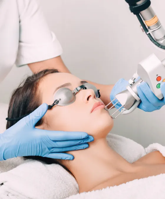 Laser skin resurfacing treatment at dermatology clinic to reduce wrinkles, acne scars, and improve skin texture.