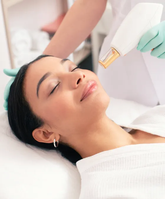 Laser facial treatment at dermatology clinic for skin rejuvenation, improving tone, texture, and radiance.