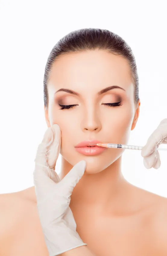 Lip filler injection at dermatology clinic for enhanced volume, definition, and a youthful appearance.