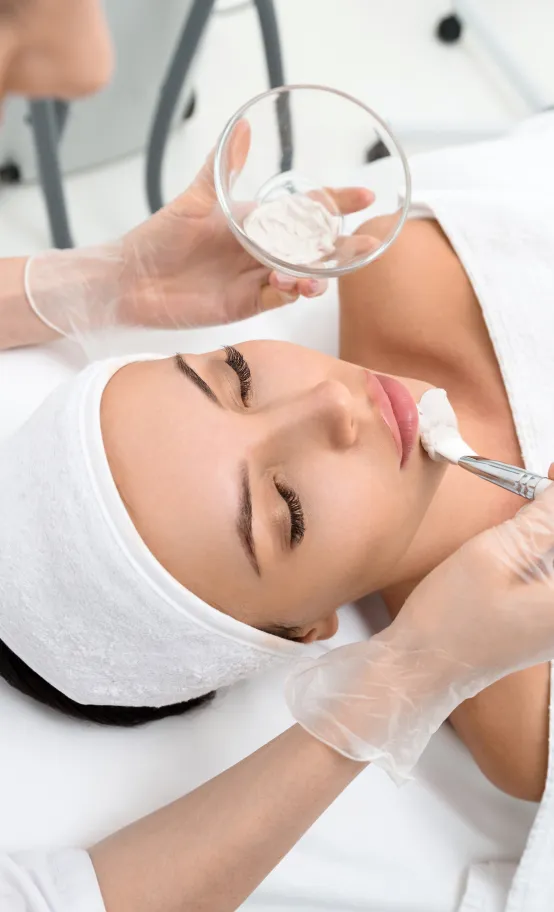 Facial treatment at dermatology clinic with professional skincare application for smooth, glowing skin.