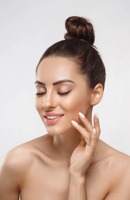 woman with radiant skin after dermatology facial treatment for hydration and skin rejuvenation